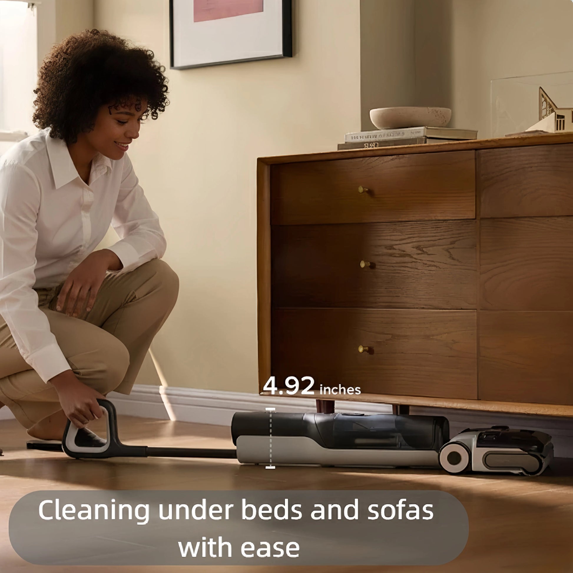 The Roborock F25 is shown in its lay-flat position, easily reaching under a low dresser. The image notes the vacuum's low profile of 4.92 inches for effective cleaning under beds and sofas.