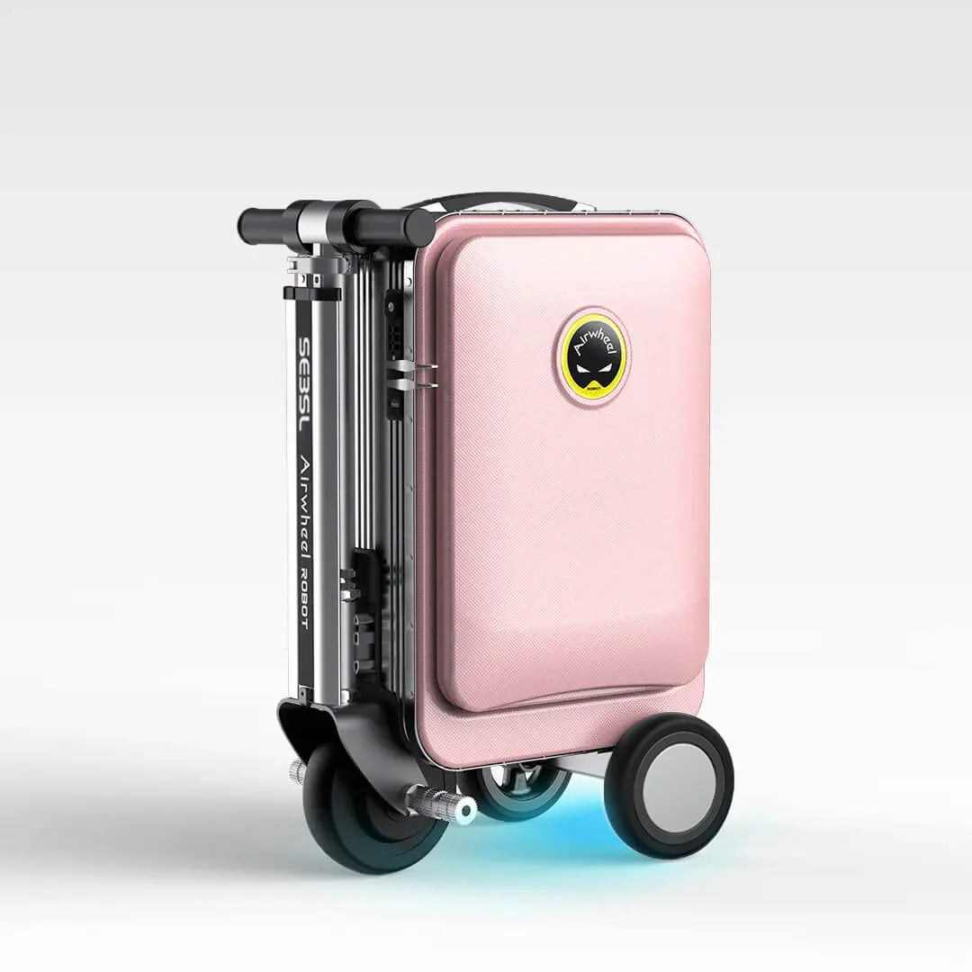 A chic pink Airwheel SE3SL ride-on suitcase in its folded, portable state, with the cool blue LED light glowing underneath