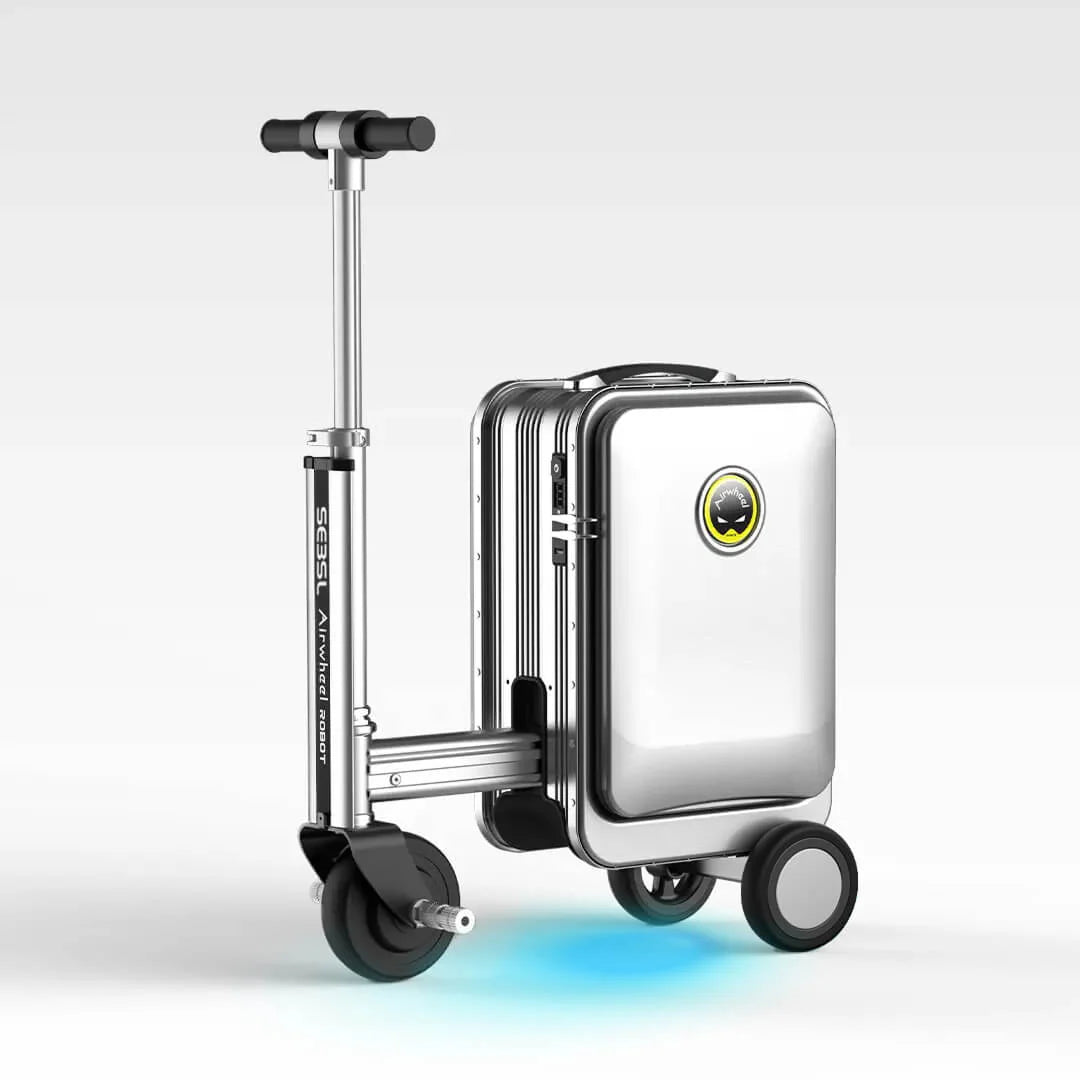 A silver Airwheel SE3SL rideable suitcase fully unfolded into scooter mode, showcasing its polished aluminum frame, extended handlebar, and blue LED underglow