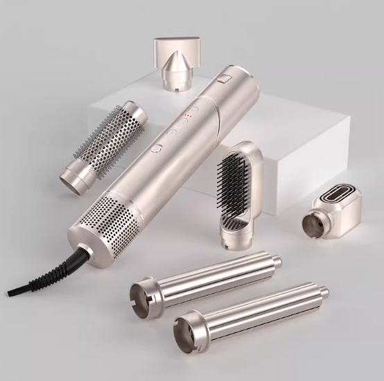 Silver 6-in-1 Ultra Styler hair styling tool displayed with interchangeable attachments on minimalist white block. Features ergonomic grip, sleek finish, and advanced airflow system for smooth styling.