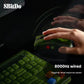 A hand using the 8BitDo Retro R8 Mouse on a dark desk, paired with a matching green mechanical keyboard. The mouse delivers an ultra-fast 8000Hz wired polling rate, ensuring zero input lag and flagship-level responsiveness for competitive gaming.