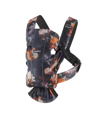 Floral print BabyBjörn Carrier One Cotton baby carrier front view featuring soft cotton fabric, ergonomic seat, and secure buckles for safe babywearing from birth.