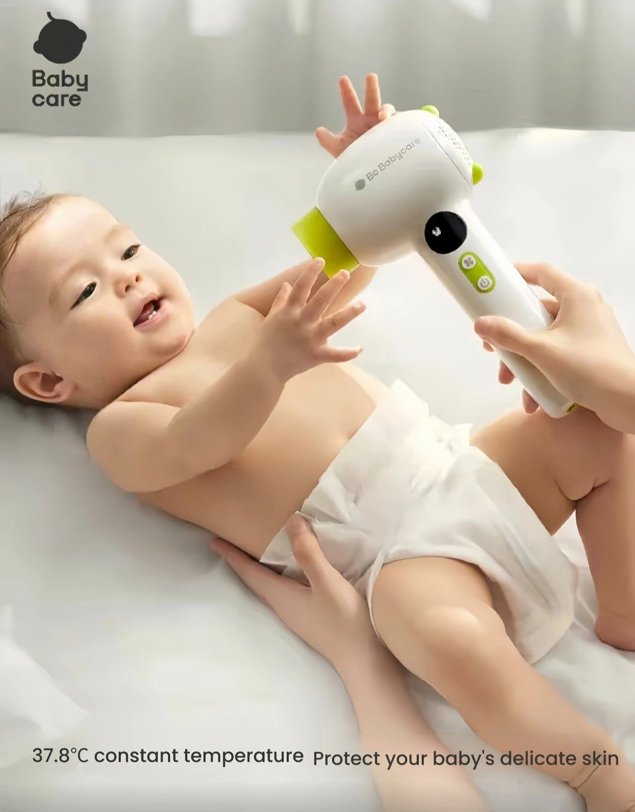 Baby reaching out to touch Babycare cordless hair dryer during use, 37.8°C constant temperature safely protects delicate infant skin from burns