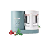 Beaba Babycook Neo baby food maker in mint green, displayed with lychee fruit and leaves—compact, stylish, and perfect for making tropical fruit purees safely at home.