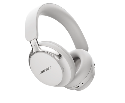 A pair of Bose QuietComfort Ultra Noise Cancelling Headphones in the White Smoke color, angled to showcase their sleek over-ear design, premium materials, and metallic accents on a white background