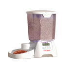 Front view of the Cat Mate automatic dry food feeder with transparent purple hopper filled with kibble. The digital display shows time and meal settings. Ideal for cats and small dogs.