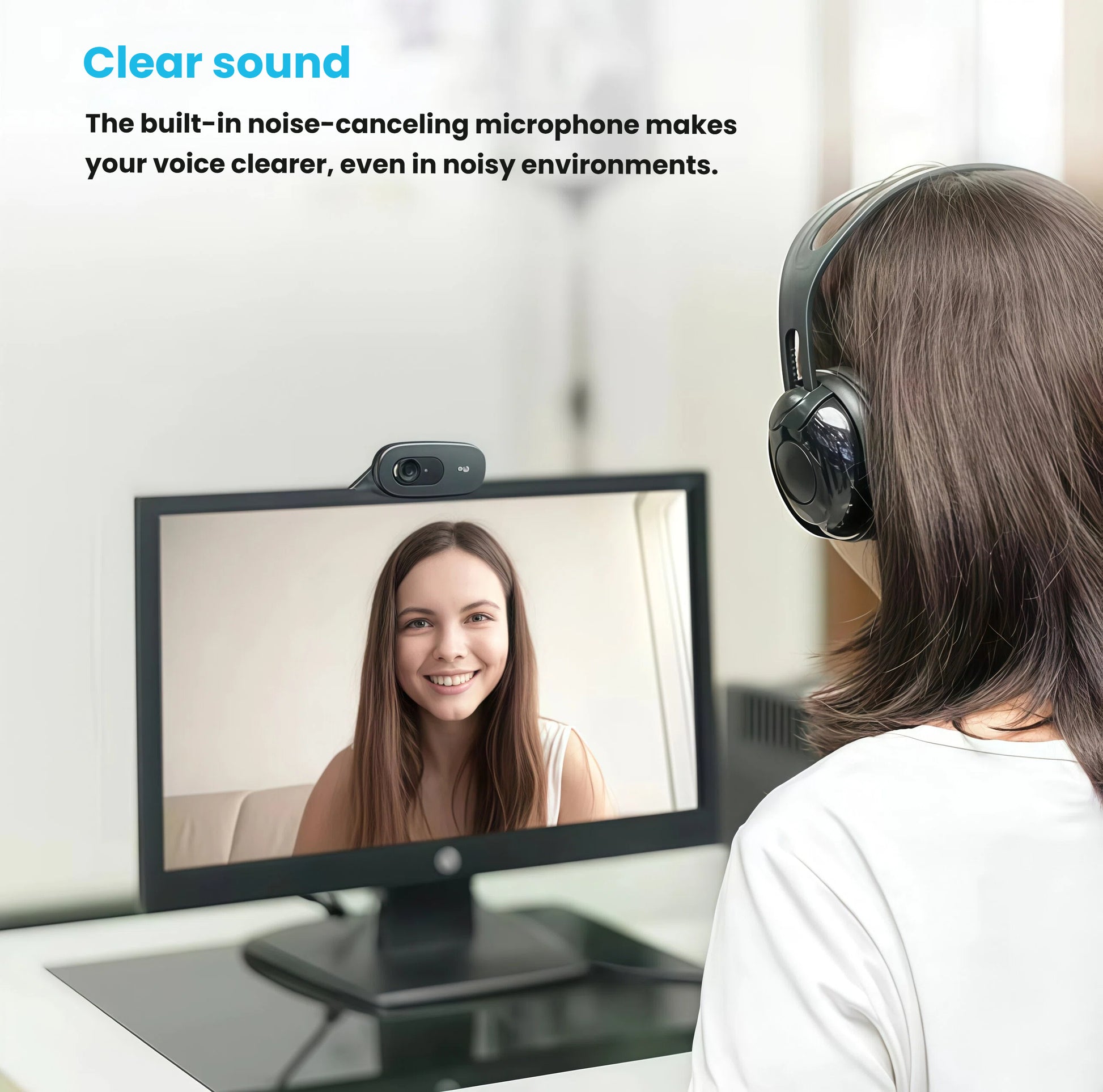 Lifestyle scene of a woman wearing a headset on a video call; the C270 webcam is mounted atop her monitor, demonstrating its built-in noise-canceling microphone.