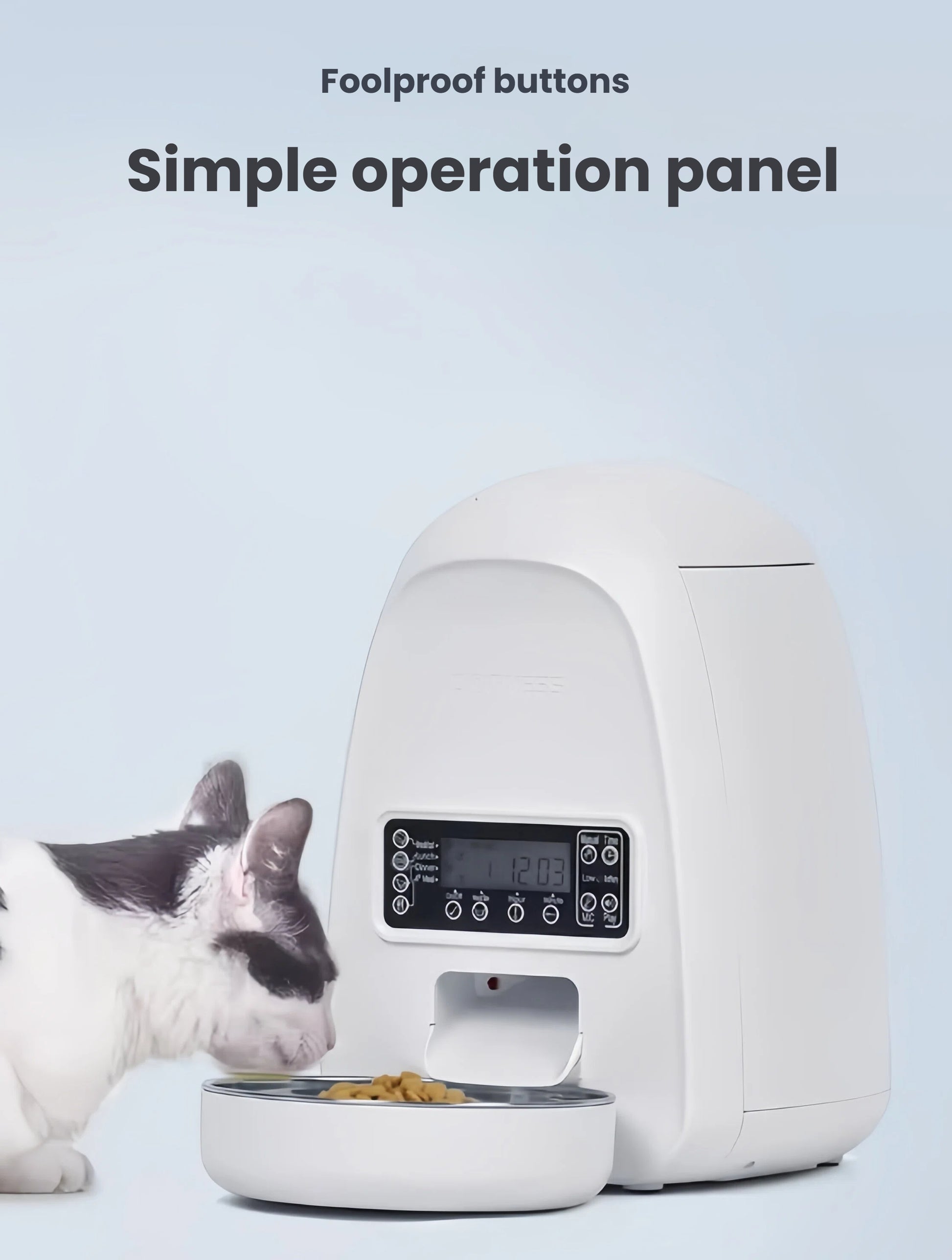 Black-and-white cat eating from white DOGNESS Mini feeder, highlighting foolproof button panel and clear LCD display.