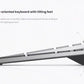 Side profile of the Dell KM7120W wireless keyboard showing the built-in tilt feet. These adjustable feet allow users to customize the keyboard angle for optimal wrist comfort and ergonomic typing, reducing strain during extended use.