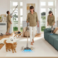 A lifestyle image demonstrating the Dreame Z10 Station's long 65-minute runtime, perfect for whole-house cleaning. A woman is vacuuming a large rug with a cat and dog nearby, while other scenes in the room show the vacuum's versatility from floor to ceiling.