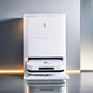 Image of the Ecovacs X5 Pro Omni, a sleek, white robot vacuum cleaner with its charging and cleaning base. The robot is docked in the station, featuring a modern design with a glowing blue indicator light on the front of the robot. The station has a minimalist look, designed for automatic cleaning and maintenance of the robot