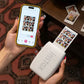 Hands holding Fujifilm Instax Mini Link 3 and smartphone. App displays 6-shot collage being printed instantly. Compact design perfect for travel, parties, or gifting memories.