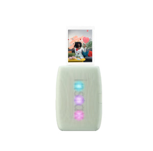Fujifilm Instax Mini Link 3 in sage green printing a photo with animated hearts. Vertical LED lights glow in blue, purple, and pink. Sleek design with modern texture and instant print output.