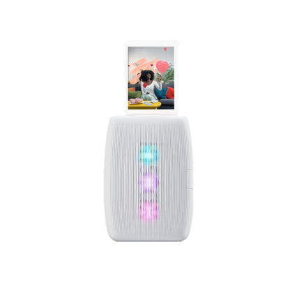 Front view of Fujifilm Instax Mini Link 3 in white, printing a photo with heart-shaped AR effects. Vertical LED lights illuminate in blue, purple, and pink during operation.