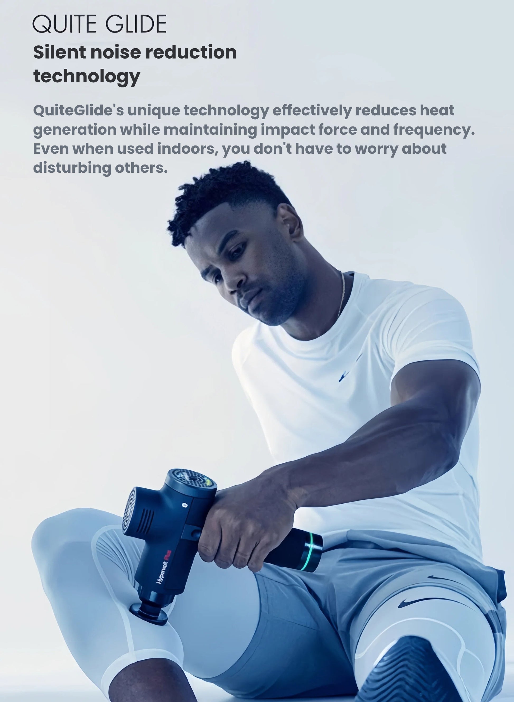 Man using Hypervolt Plus on thigh indoors, showcasing QuietGlide noise-reduction for silent, powerful relief.