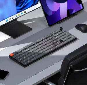 Keychron K17 Max wireless mechanical keyboard on a modern desk setup with dual monitors, mouse, and smartphone, ideal for Windows and macOS users in home or office environments.