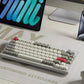 Keychron Q1 Max wireless mechanical keyboard with white and gray OSA PBT keycaps, red ESC and Enter keys, placed on a clean modern desk setup with tablet and laptop, ideal for compact workspaces and productivity.