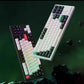 Floating view of Keychron Q3 HE mechanical keyboard in black and white colorways, featuring vibrant RGB backlighting, 60% compact layout, and sleek aluminum frame against a futuristic space-themed background.