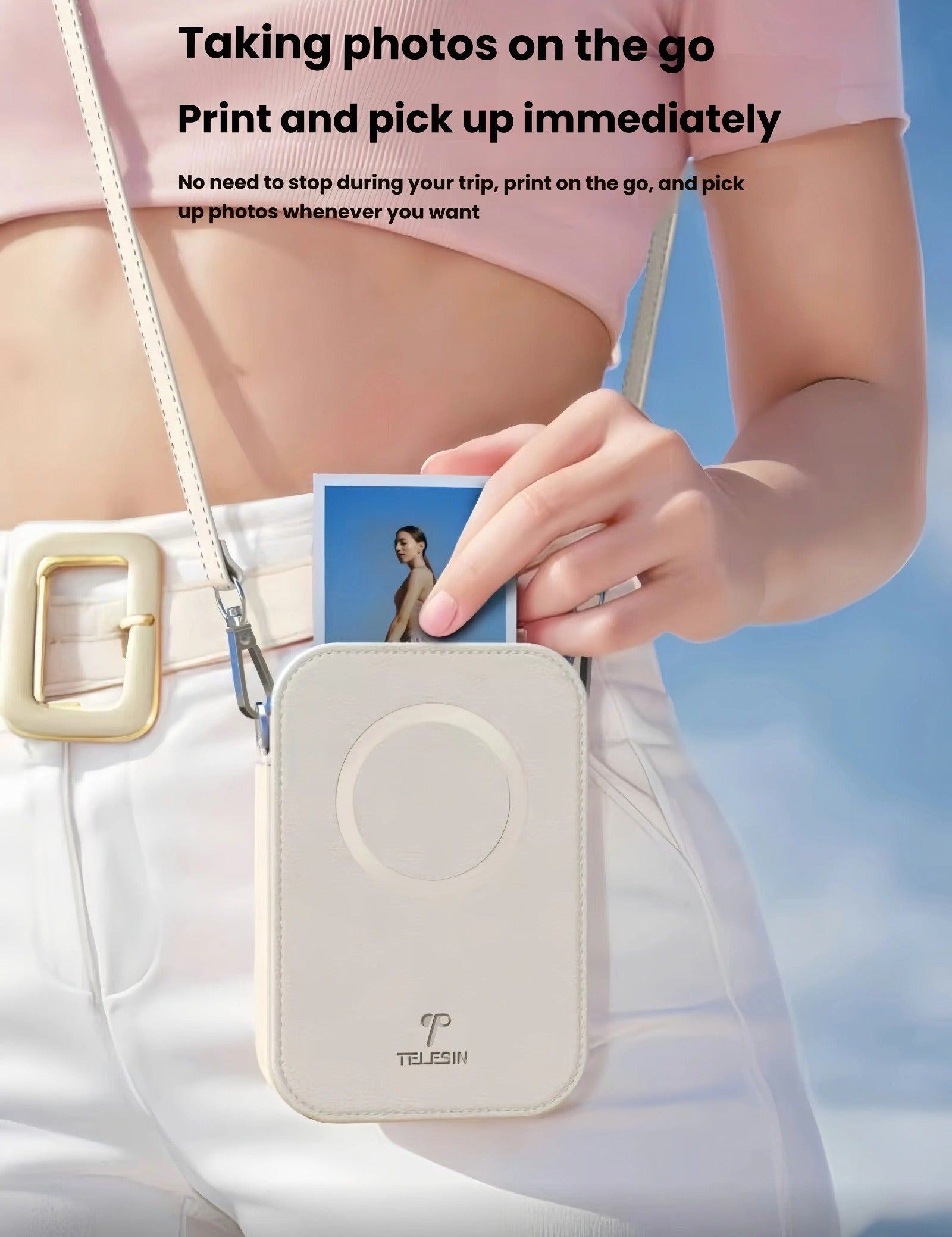 Woman wearing Liene x TELESIN portable photo printer as a crossbody bag, holding a freshly printed sticky-backed photo. Ideal for travel, festivals, or daily use—print and pick up instantly.
