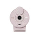 Studio shot of the rose (pink-speckled) Logitech Brio 300 webcam facing forward, privacy cover closed.