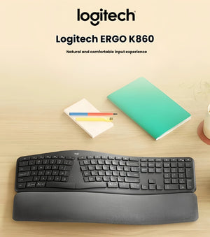  Lifestyle photo of the Logitech ERGO K860 split keyboard placed on a light wooden desk beside notebooks and colored pencils, emphasizing its sleek design and comfortable wrist support.