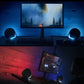 Split-screen photo showing the Logitech G560 speakers syncing their RGB colors to on-screen action in Battlefield 1 and a racing game for immersive ambient lighting.