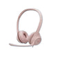 Soft rose-colored Logitech H390 headset with matching boom mic, isolated on white.
