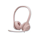 Soft rose-colored Logitech H390 headset with matching boom mic, isolated on white.
