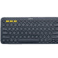 Top-down view of the dark gray Logitech K380 with yellow-accented Easy-Switch keys, emphasizing its professional look and multi-device Bluetooth connectivity.