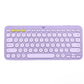 Pastel lavender Logitech K380 keyboard viewed from above, emphasizing its trendy color and the ability to switch between three Bluetooth devices with one tap.
