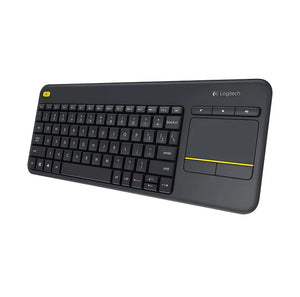 3/4-angle view of the Logitech K400 Plus showing the slim profile and built-in touchpad with yellow accent line, ideal for couch or living-room use.