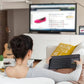 Woman on a sofa using the Logitech K400 Plus to shop online on a big-screen TV, showcasing the keyboard’s convenience for living-room browsing and media control.