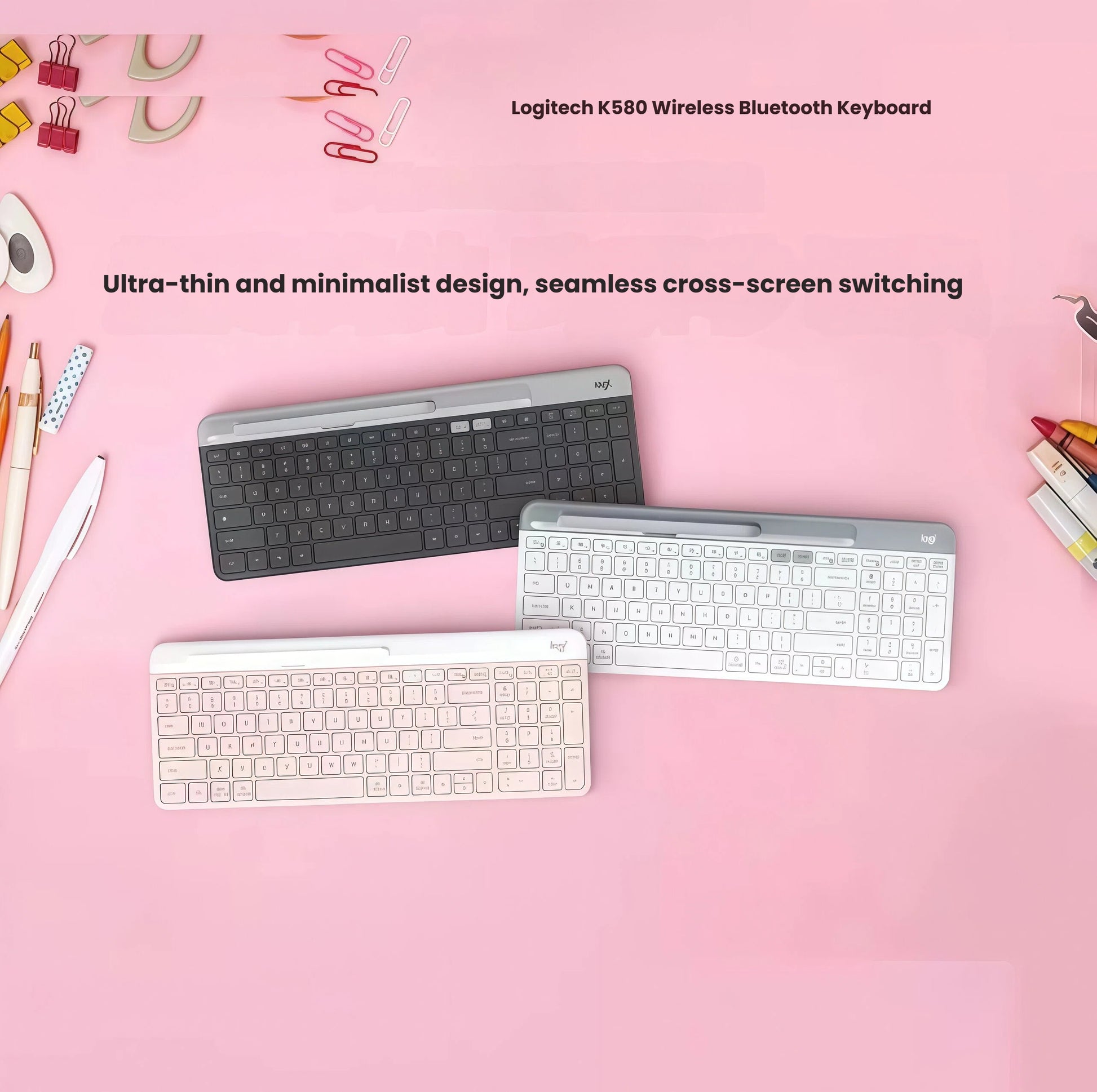 Flat-lay of three Logitech K580 keyboards (graphite, off-white, and rose) on a pink desk, surrounded by office accessories, emphasizing minimalist design and seamless cross-screen switching.
