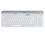 Clean overhead view of the off-white Logitech K580 wireless keyboard, highlighting its ultra-thin profile, integrated device slot, and quiet low-profile keys.