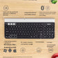 Annotated top view of the Logitech K780 on a wooden surface, labeling 3-device switching, built-in phone/tablet stand, Unifying & Bluetooth connectivity, 10 m range, and OS compatibility with Windows, Mac, Android, and iOS.