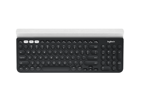 Overhead shot of the black Logitech K780 wireless keyboard with white Easy-Switch keys and built-in rubber cradle, showing the full-size layout and dual connectivity indicators.