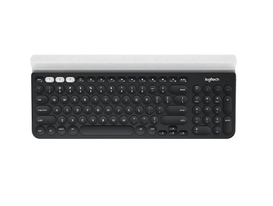 Overhead shot of the black Logitech K780 wireless keyboard with white Easy-Switch keys and built-in rubber cradle, showing the full-size layout and dual connectivity indicators.