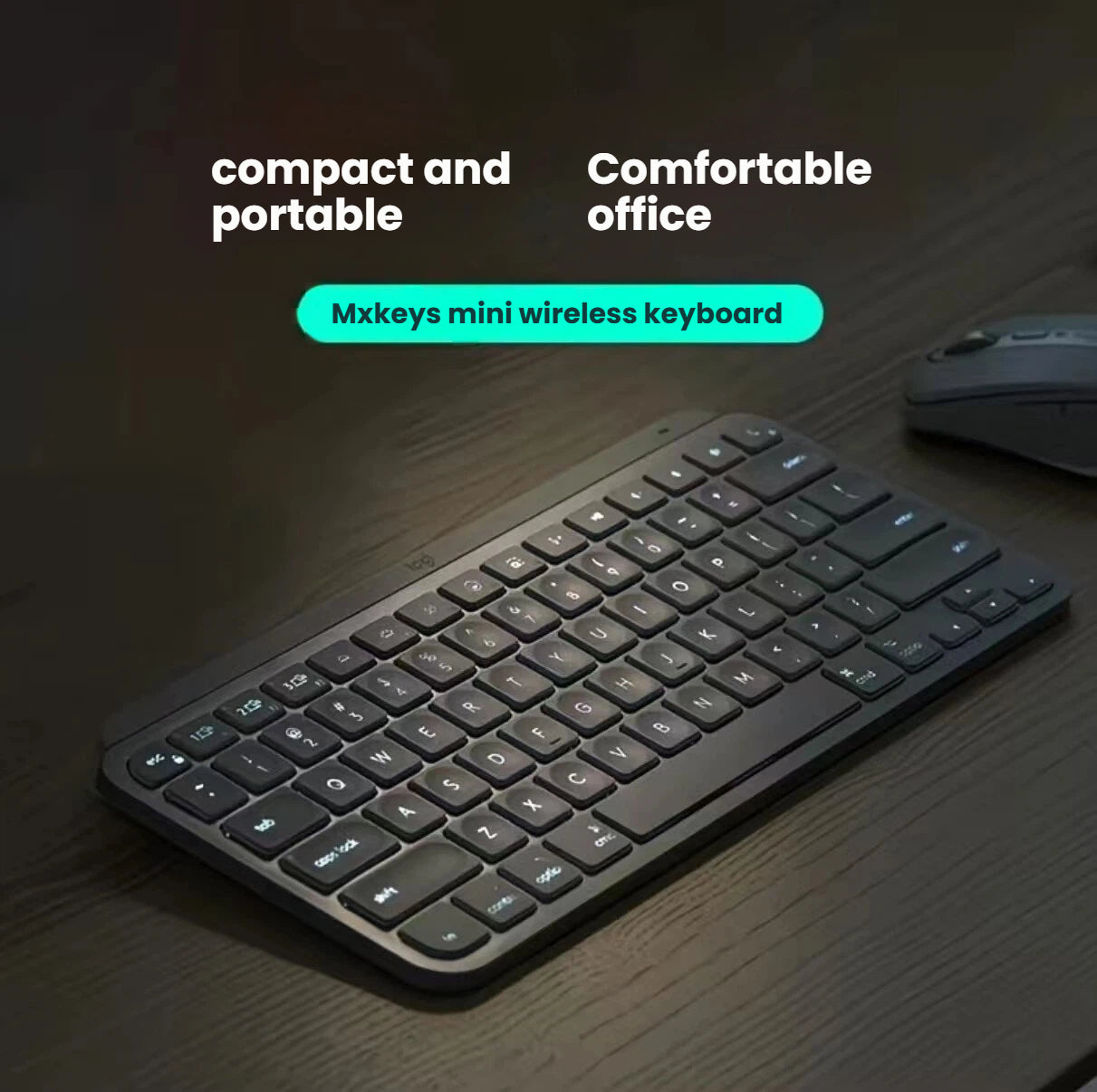 Lifestyle photo of the graphite Logitech MX Keys Mini illuminated wireless keyboard on a dark wood desk next to a Logitech mouse, emphasizing compact portability and comfortable office use.