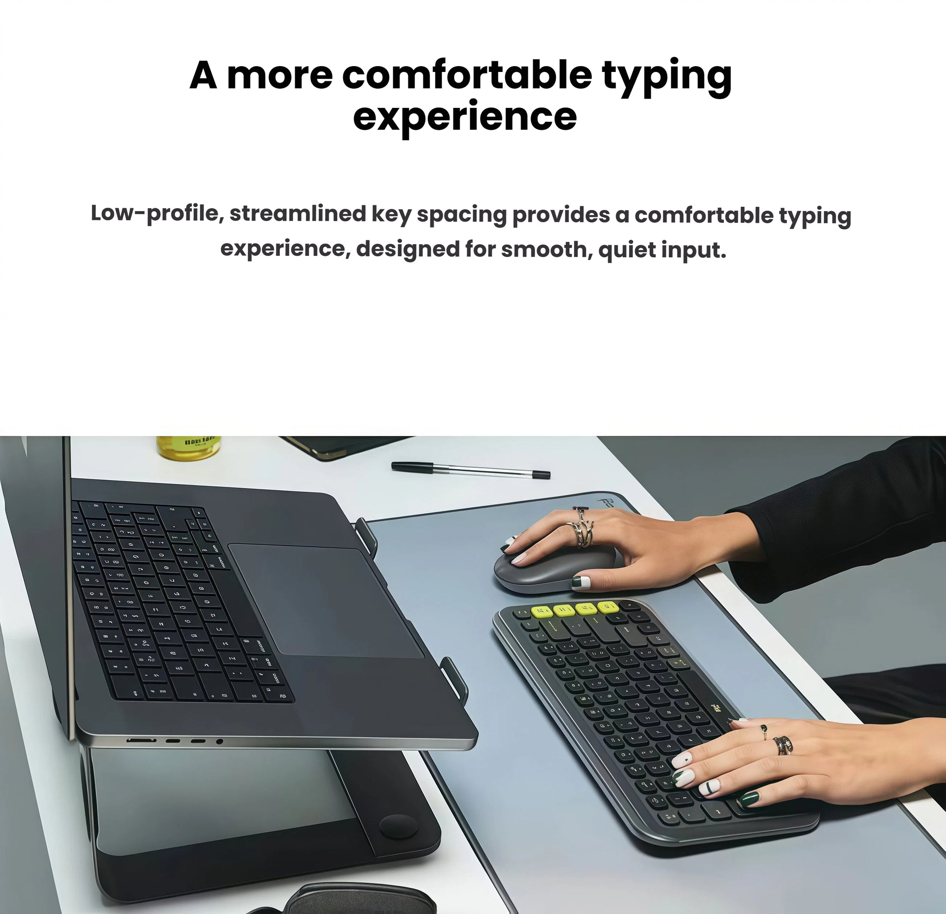 Side-angle lifestyle photo of the black POP Icon Combo in use beside a laptop, illustrating the ergonomic low-profile key design and quiet keystrokes.