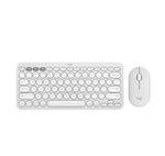  Over-shoulder shot of the off-white Pebble 2 Combo being used beside a laptop, highlighting Silent Touch technology and low-profile quiet keys.