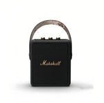 Front view of the Marshall Stockwell II portable wireless speaker in black with camouflage-pattern carry strap, highlighting its rugged, travel-ready style.