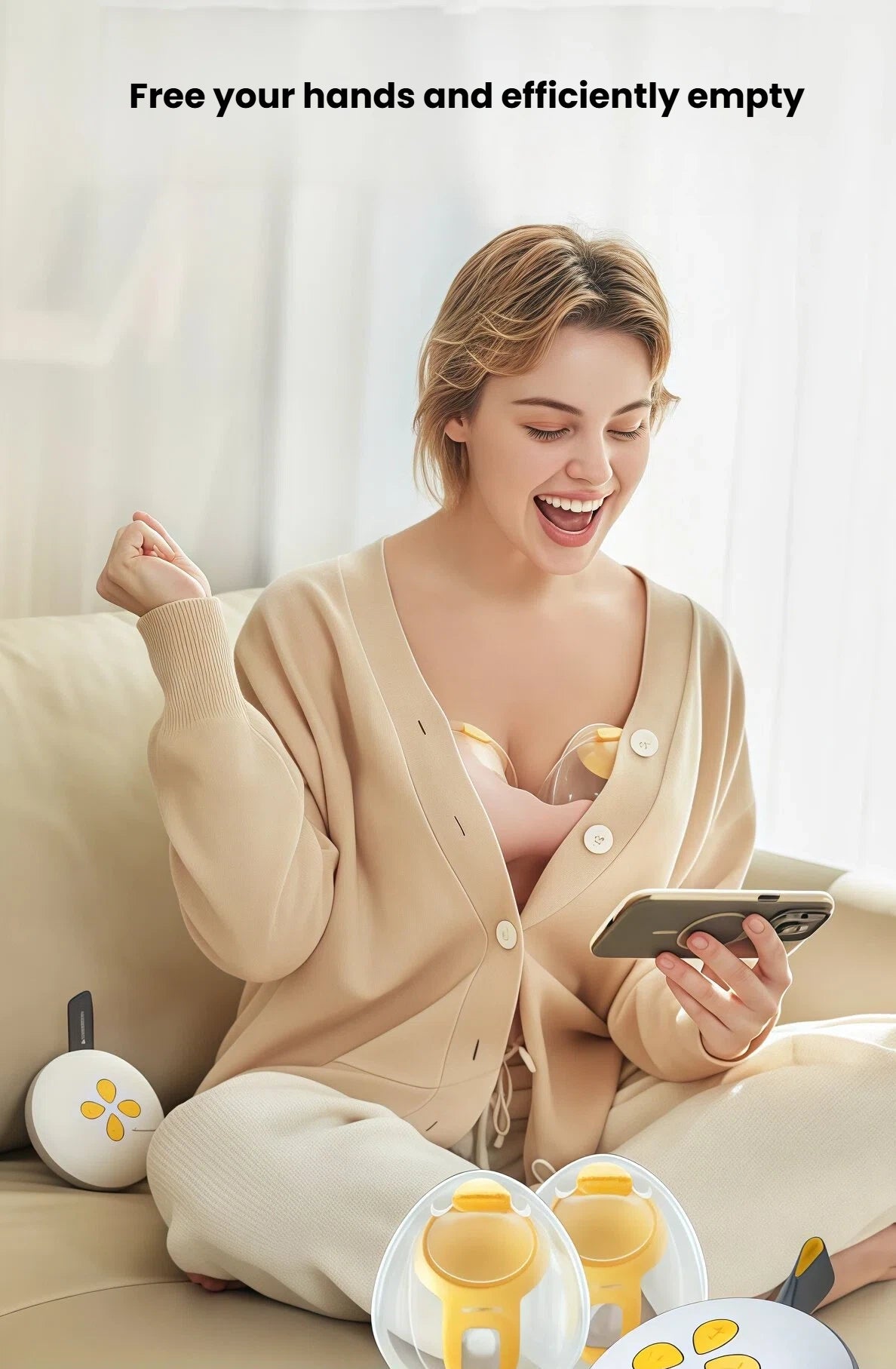 Woman using Medela Swing Maxi hands-free double breast pump while sitting on a couch and smiling at her phone. The pump fits securely inside her bra, freeing her hands for daily tasks.