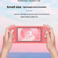 Two hands gripping the coral Switch Lite against a pastel sky background, emphasizing its small size and lightweight build for on-the-go gaming.