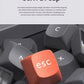 Detailed view of orange ESC keycap made from durable OSA PBT material with spherical angle design, offering oil-resistant, wear-resistant surface and long-lasting two-color injection molding lettering.