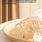 Close-up of October Crystal breast pump parts laid out on a plate: transparent milk bottle, silicone flange, and valve—all made from BPA-free, food-grade materials ensuring safe milk collection and consumption
