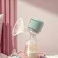 October Crystal portable electric breast pump sitting on a nightstand next to a baby bottle; milk collected in transparent 180ml bottle with measurement markings, ideal for home or travel use