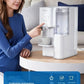 A woman dispensing hot water into a cup from the Philips ADD686U countertop water purifier, which integrates purification and heating to replace multiple kitchen appliances like kettles and filter pitchers.