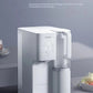 The sleek white Philips desktop drinking water machine sitting on a modern kitchen counter, showcasing its convenient no-installation design and advanced Aquaporin purification technology.