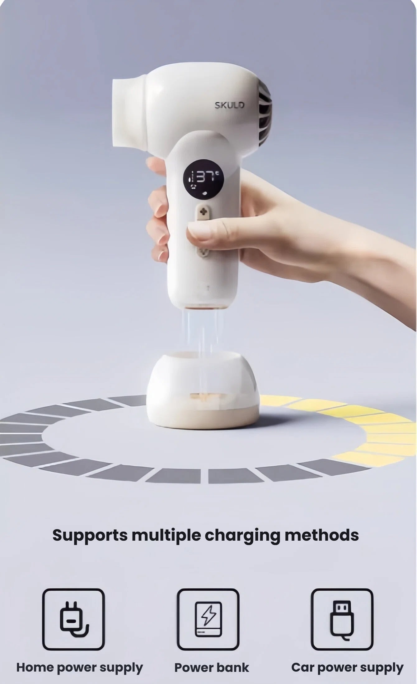 SKULD baby hair dryer charging wirelessly on base; supports home power supply, portable power bank, and car charger for flexible use at home or on travel