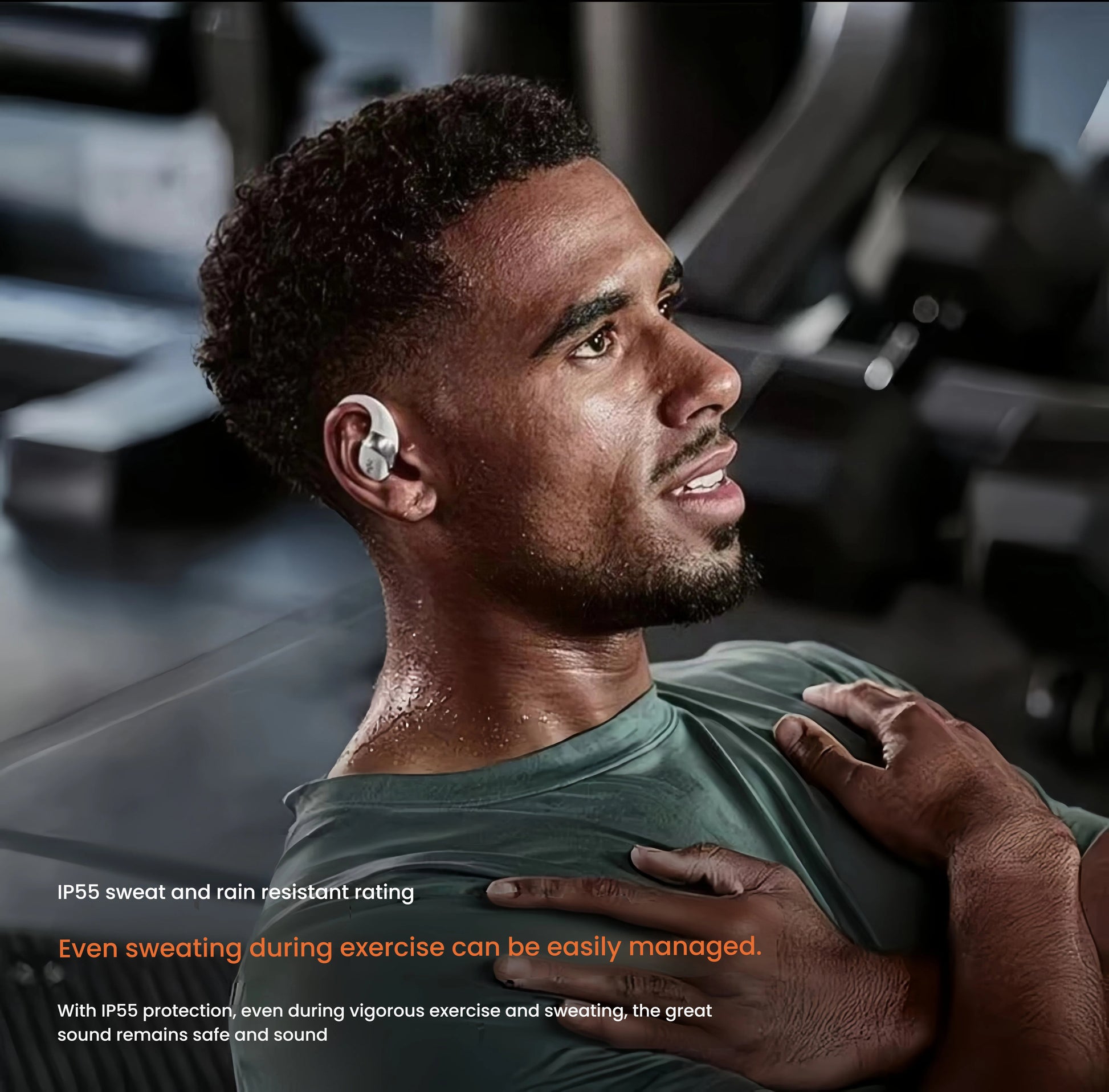 Man sweating during workout wearing Shokz OpenFit 2+ earbuds — IP55 rated protection ensures durability and performance even during vigorous exercise and heavy perspiration.